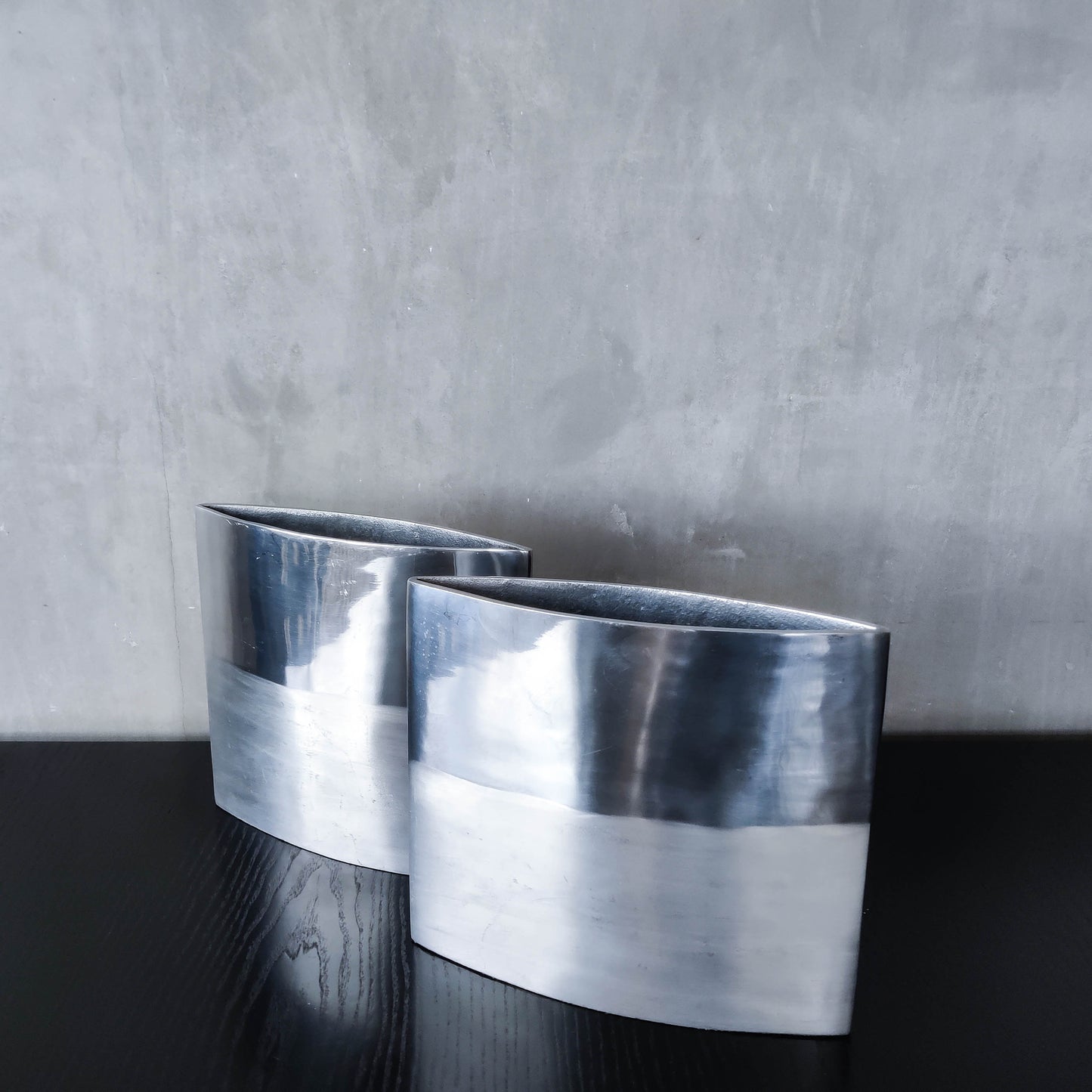 Pair of vintage 00s flat sculptural hand cast aluminium vases