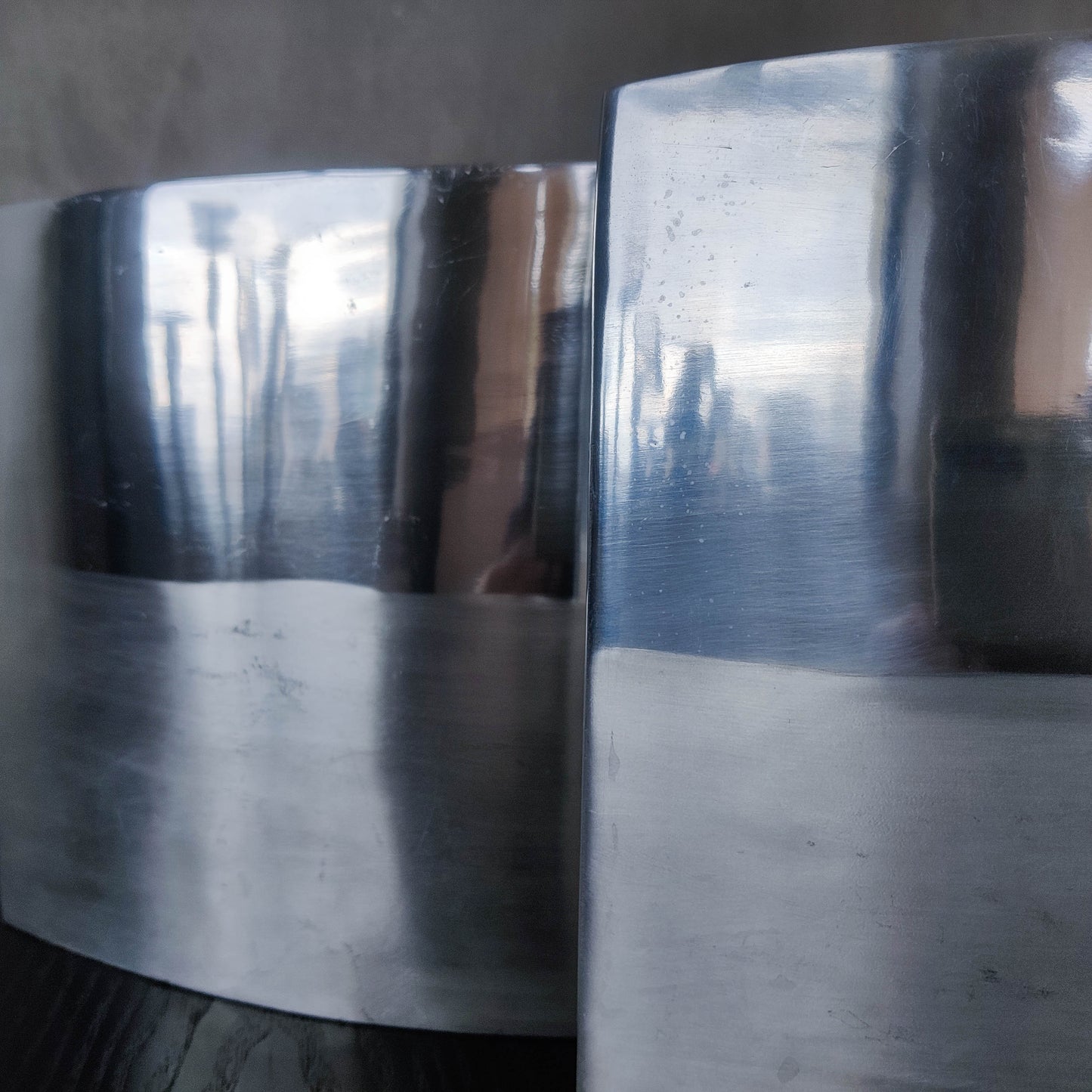 Pair of vintage 00s flat sculptural hand cast aluminium vases