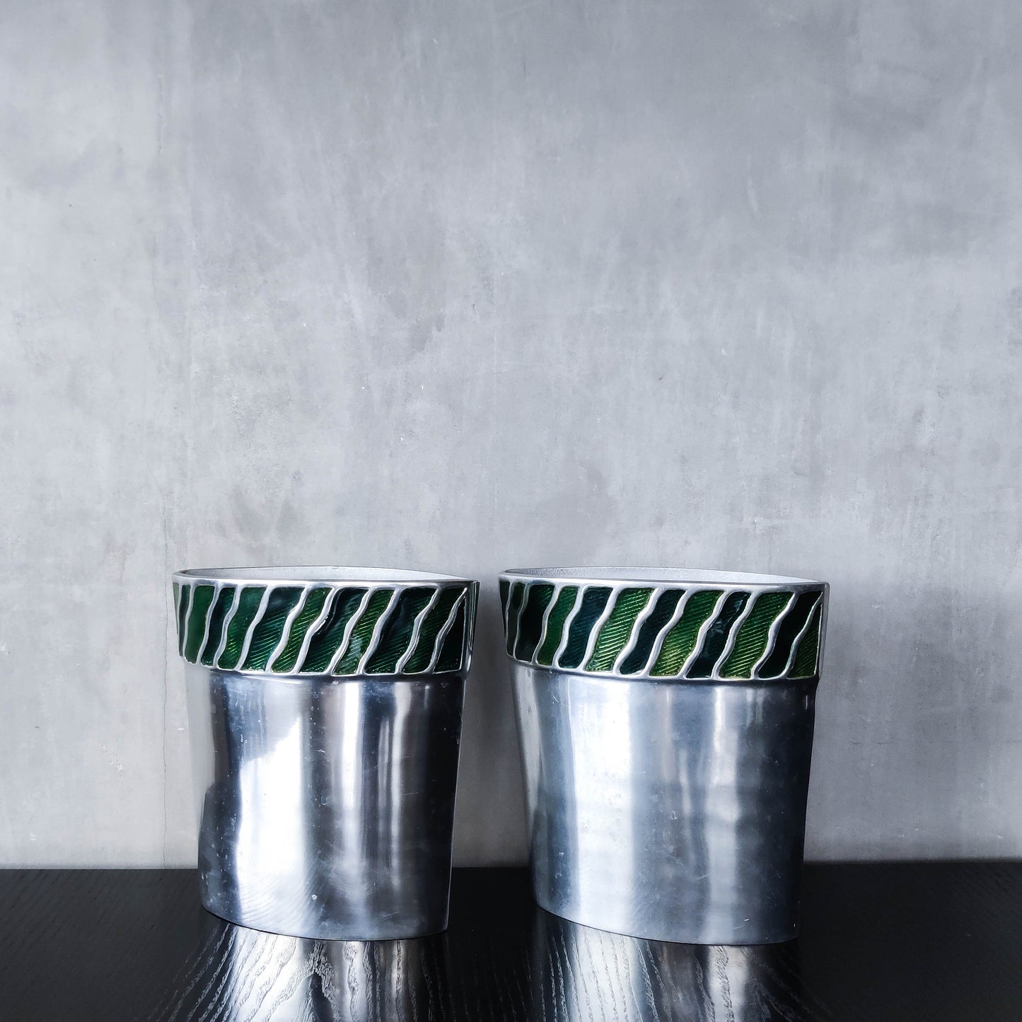 Pair of vintage 00s cast aluminium sculptural vases with green enamel wave inlay