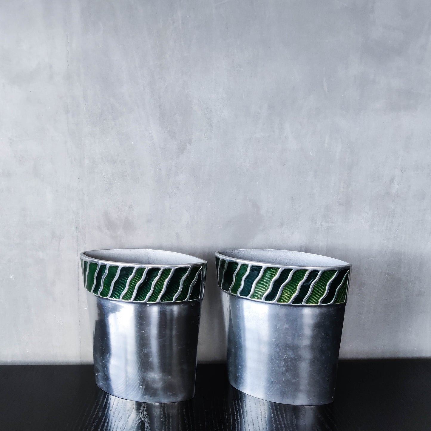 Pair of vintage 00s cast aluminium sculptural vases with green enamel wave inlay