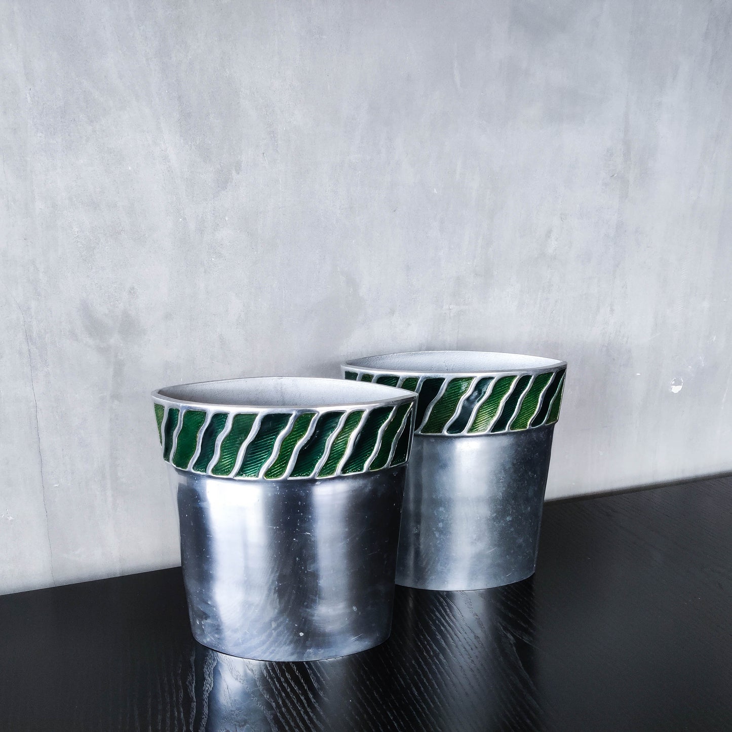 Pair of vintage 00s cast aluminium sculptural vases with green enamel wave inlay