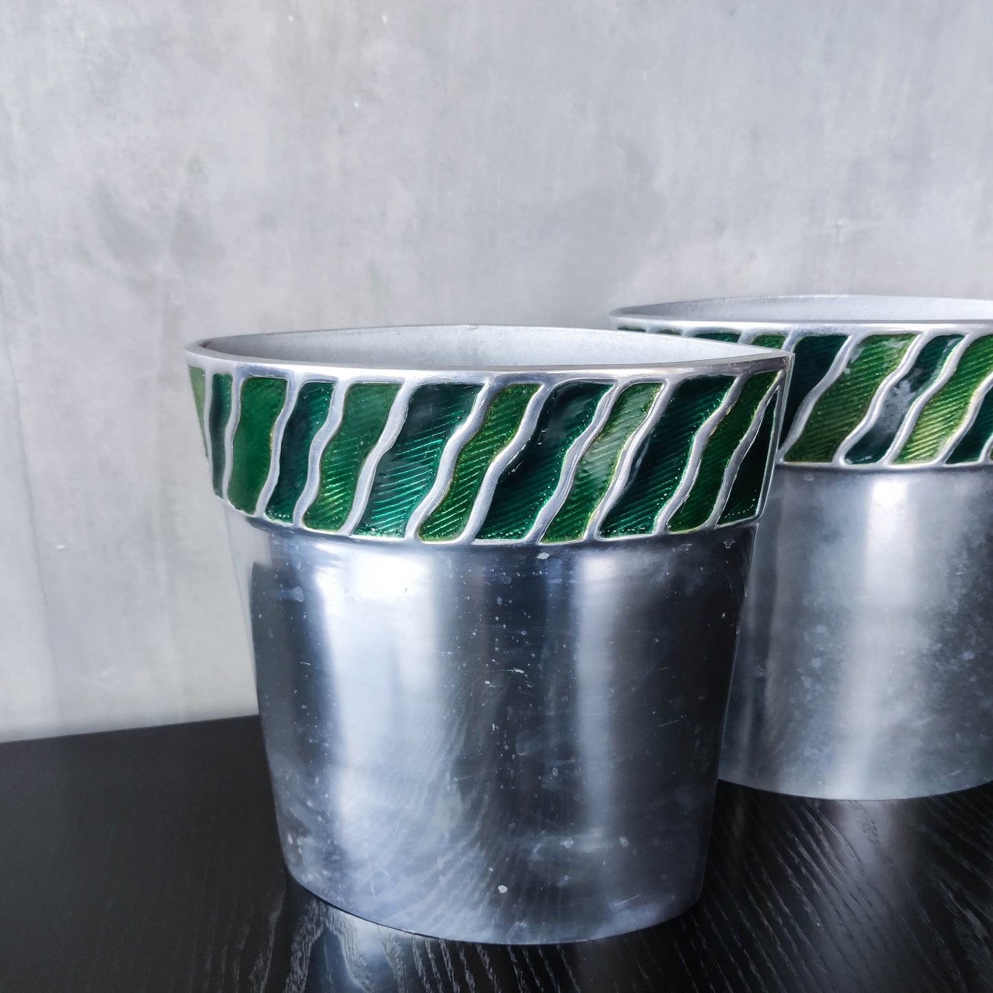 Pair of vintage 00s cast aluminium sculptural vases with green enamel wave inlay
