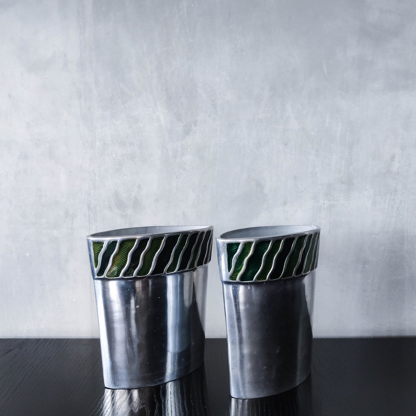 Pair of vintage 00s cast aluminium sculptural vases with green enamel wave inlay