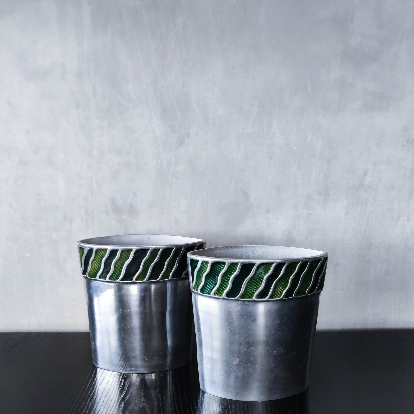 Pair of vintage 00s cast aluminium sculptural vases with green enamel wave inlay