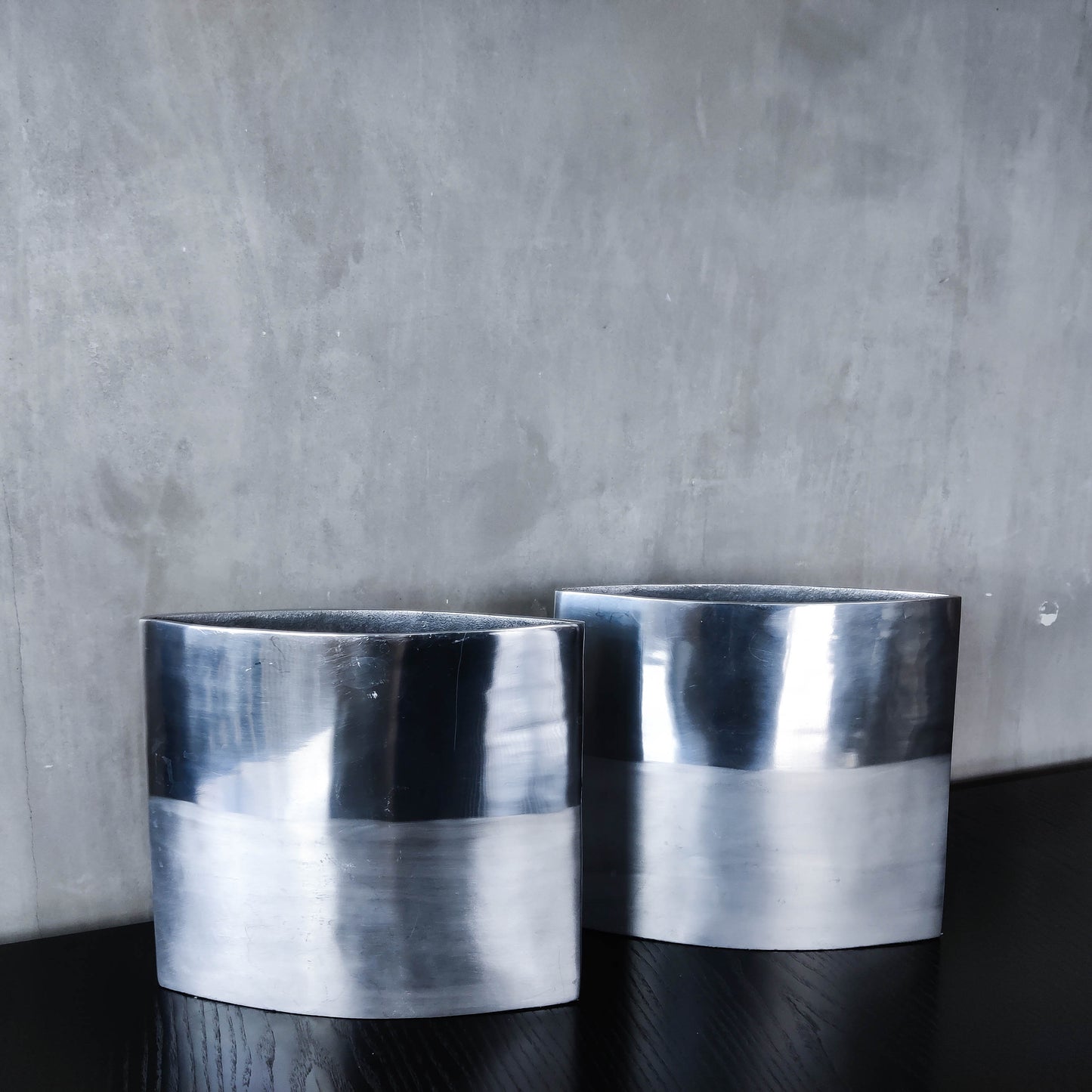 Pair of vintage 00s flat sculptural hand cast aluminium vases