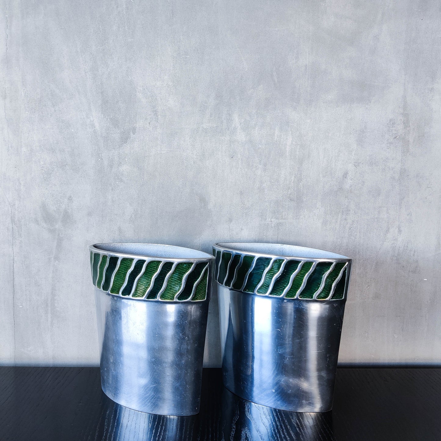 Pair of vintage 00s cast aluminium sculptural vases with green enamel wave inlay