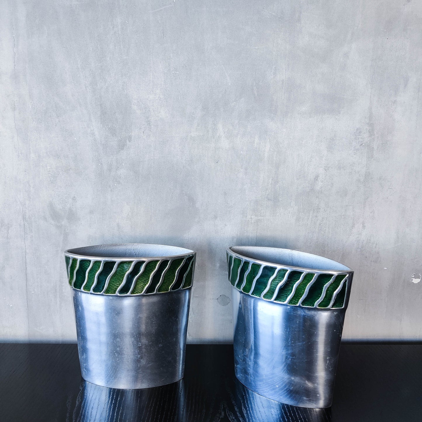 Pair of vintage 00s cast aluminium sculptural vases with green enamel wave inlay