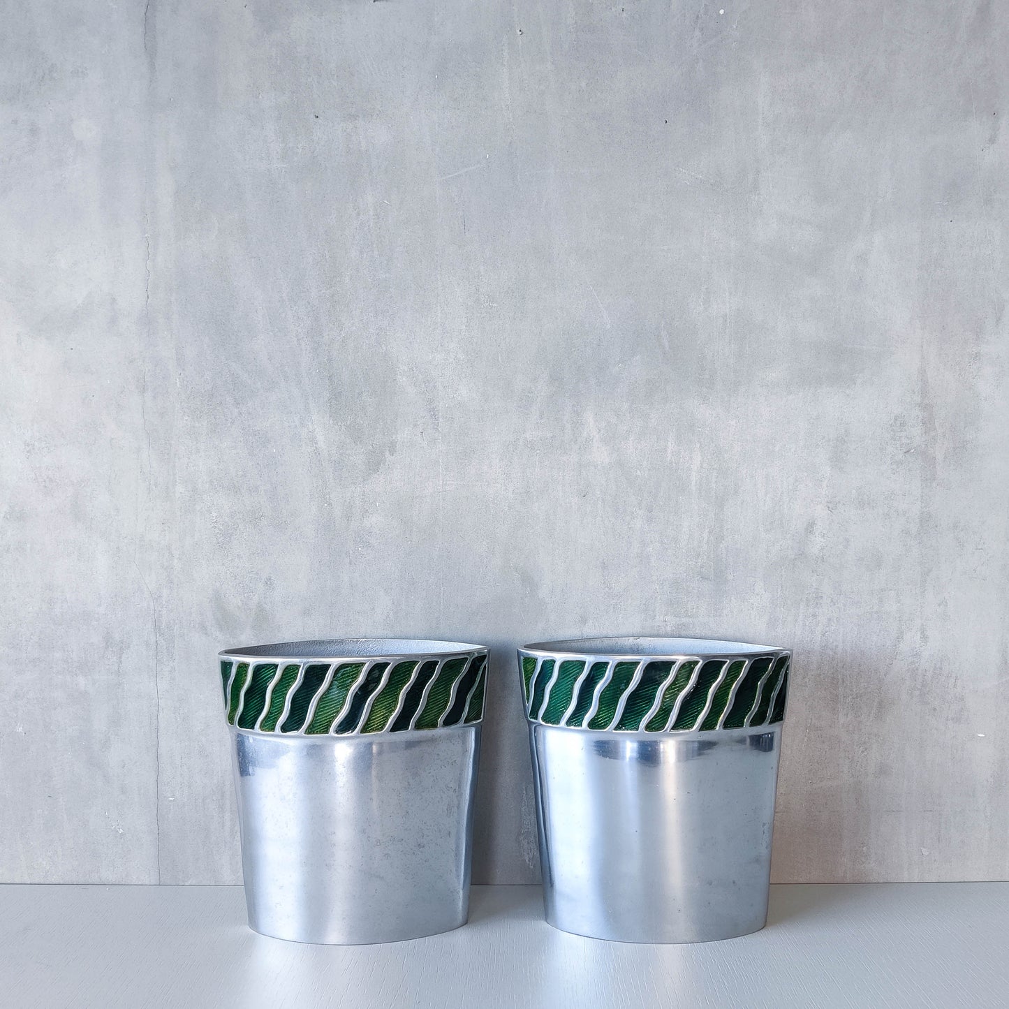 Pair of vintage 00s cast aluminium sculptural vases with green enamel wave inlay