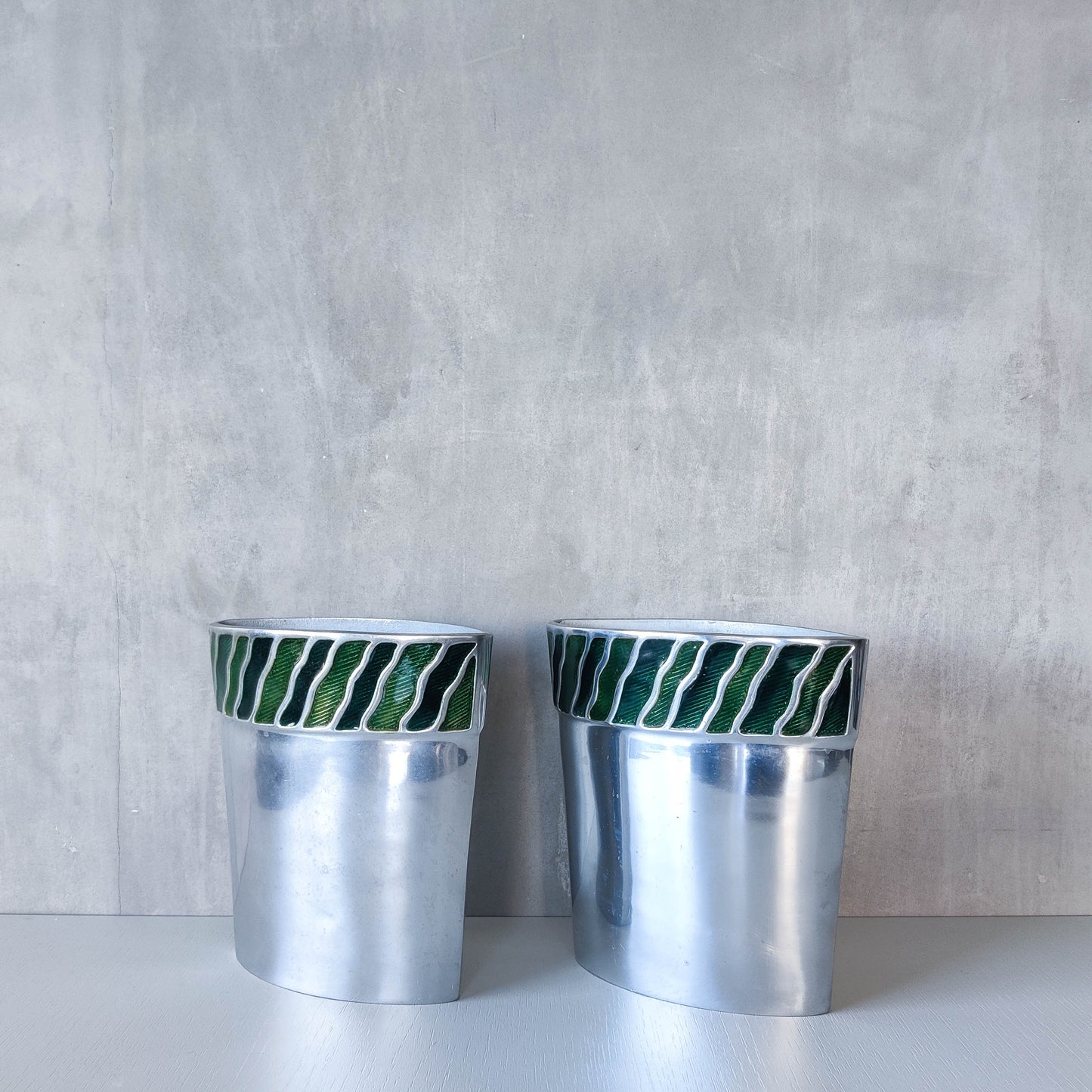 Pair of vintage 00s cast aluminium sculptural vases with green enamel wave inlay