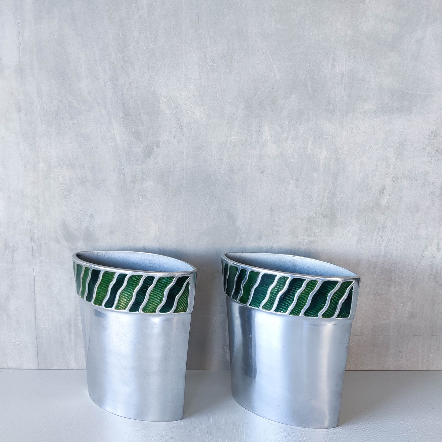 Pair of vintage 00s cast aluminium sculptural vases with green enamel wave inlay