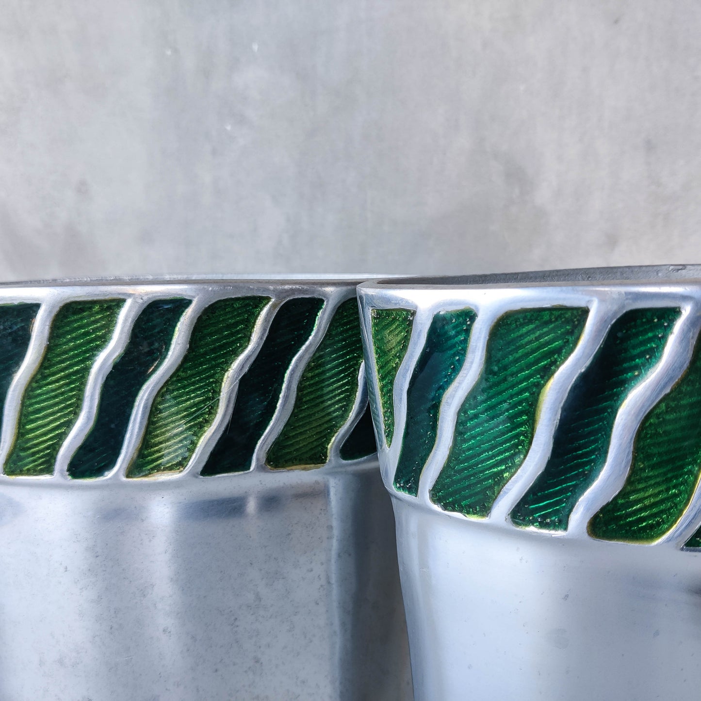 Pair of vintage 00s cast aluminium sculptural vases with green enamel wave inlay