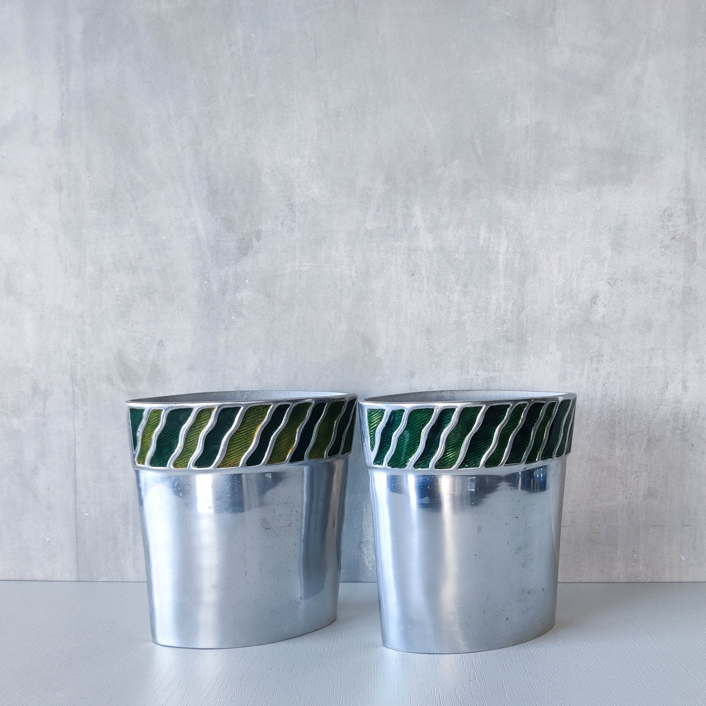 Pair of vintage 00s cast aluminium sculptural vases with green enamel wave inlay