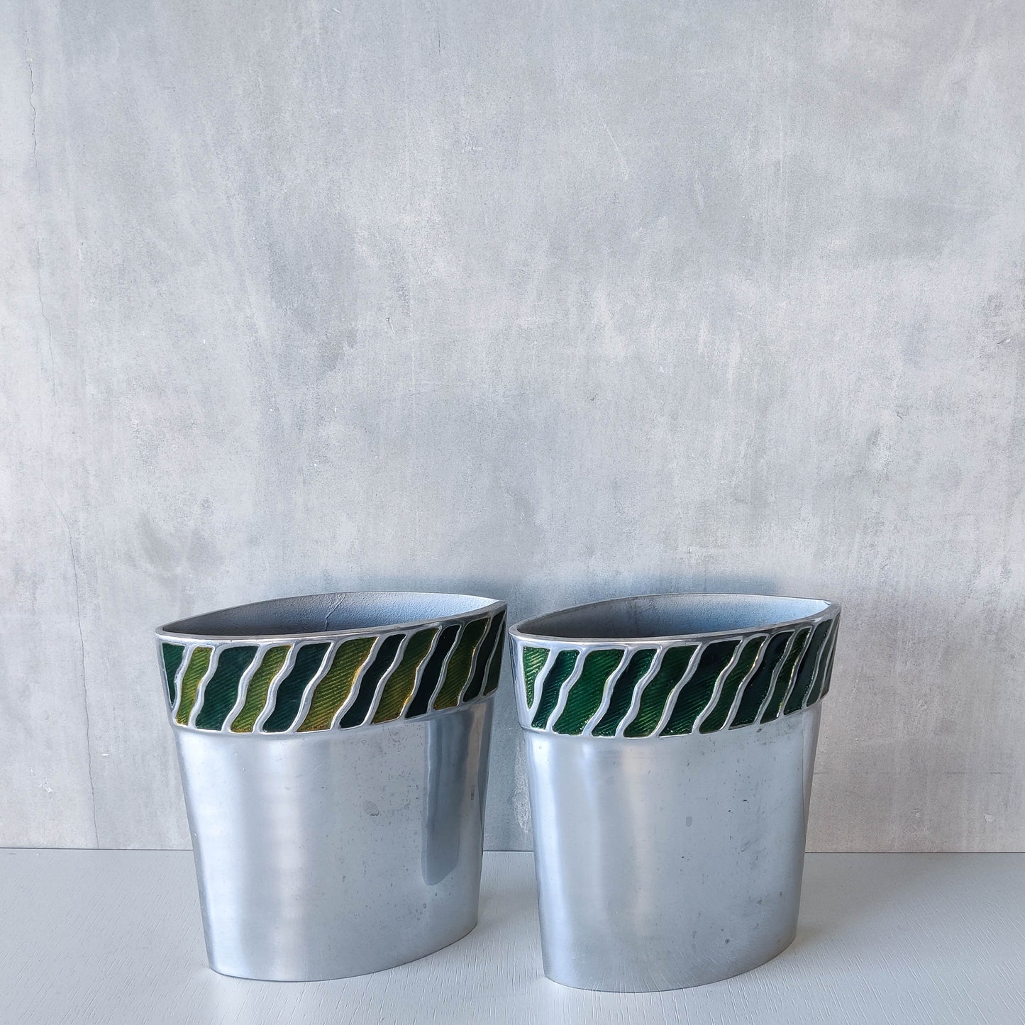 Pair of vintage 00s cast aluminium sculptural vases with green enamel wave inlay