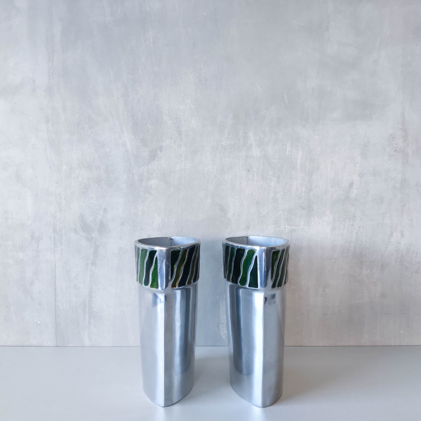 Pair of vintage 00s cast aluminium sculptural vases with green enamel wave inlay