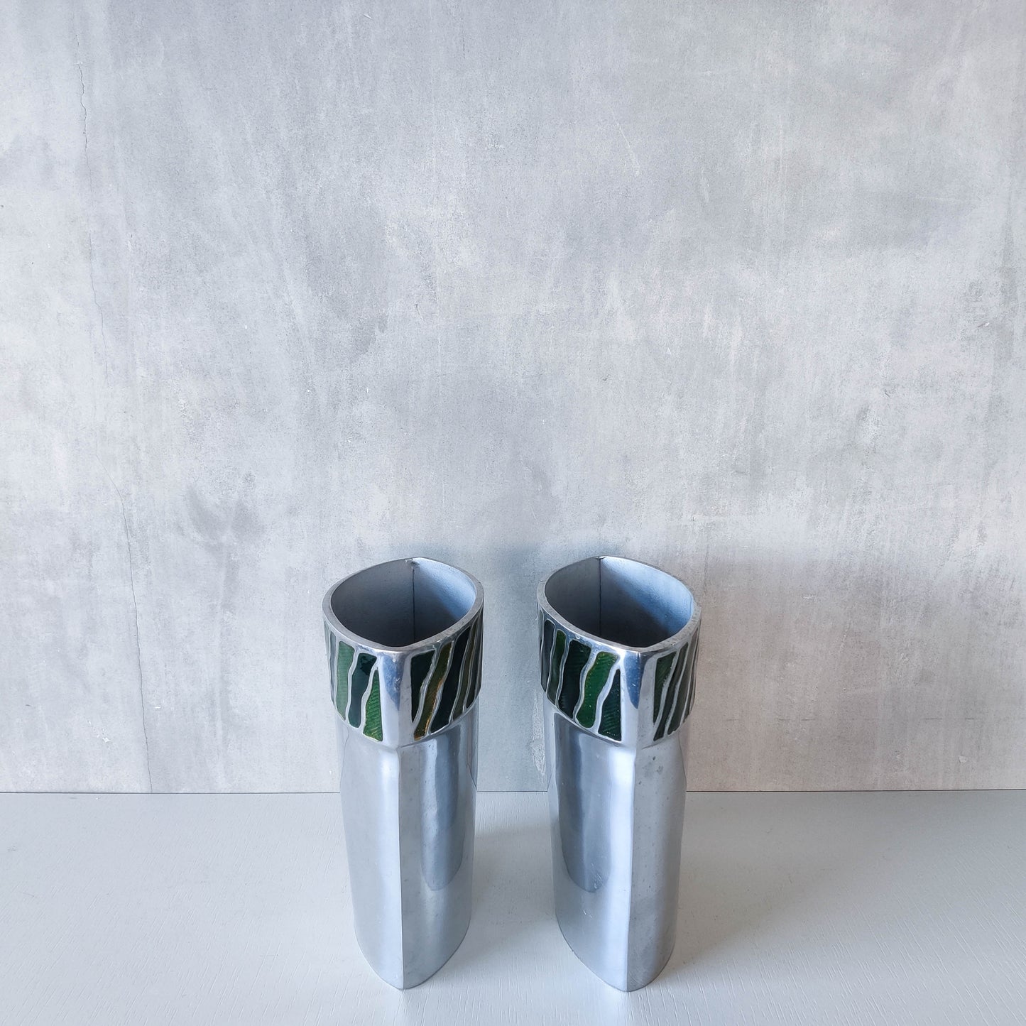 Pair of vintage 00s cast aluminium sculptural vases with green enamel wave inlay