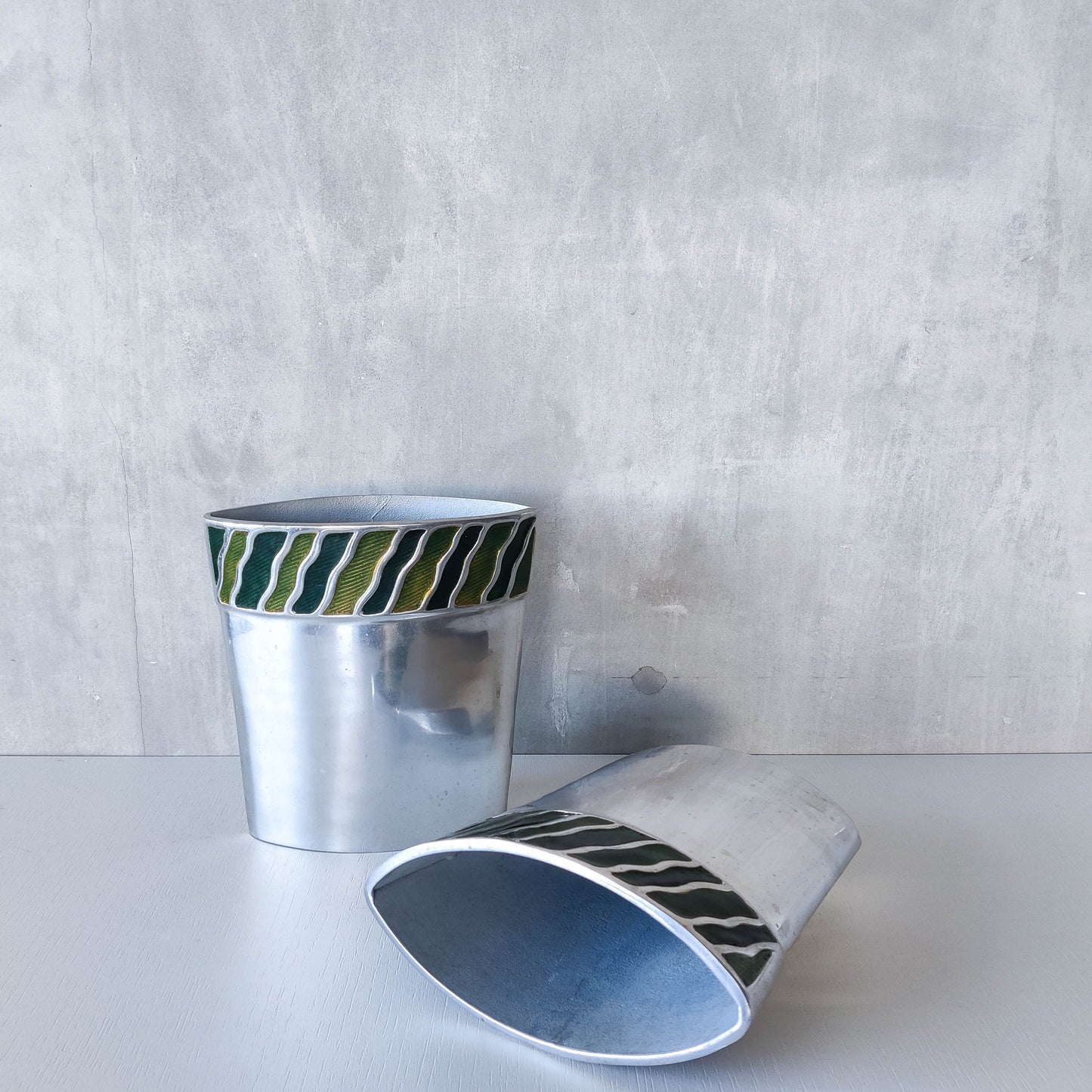 Pair of vintage 00s cast aluminium sculptural vases with green enamel wave inlay