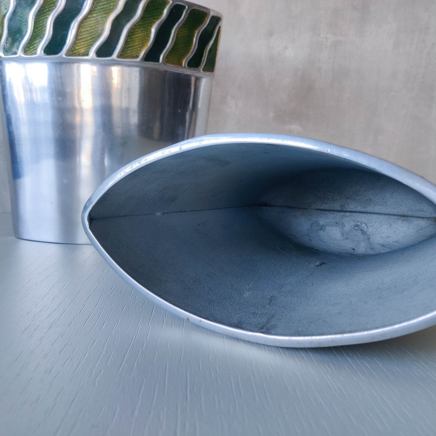 Pair of vintage 00s cast aluminium sculptural vases with green enamel wave inlay