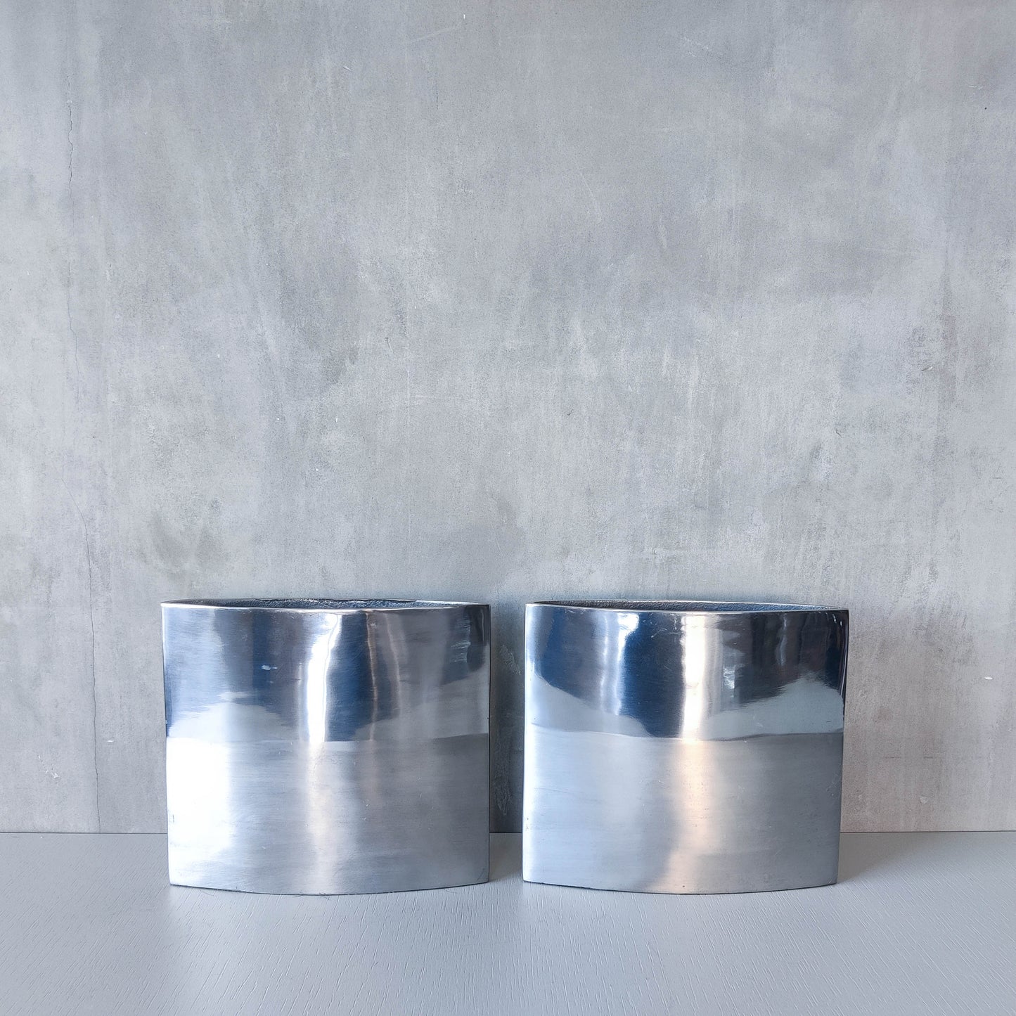 Pair of vintage 00s flat sculptural hand cast aluminium vases