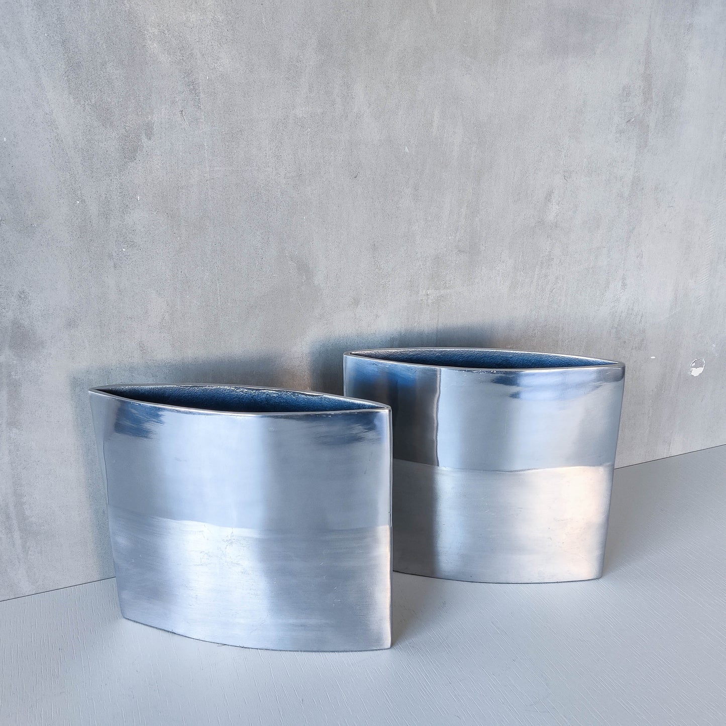 Pair of vintage 00s flat sculptural hand cast aluminium vases