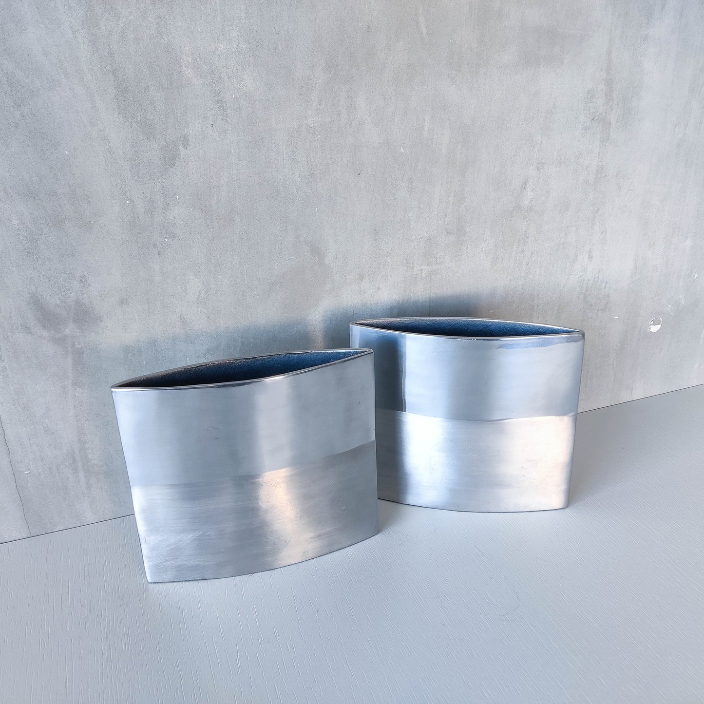 Pair of vintage 00s flat sculptural hand cast aluminium vases