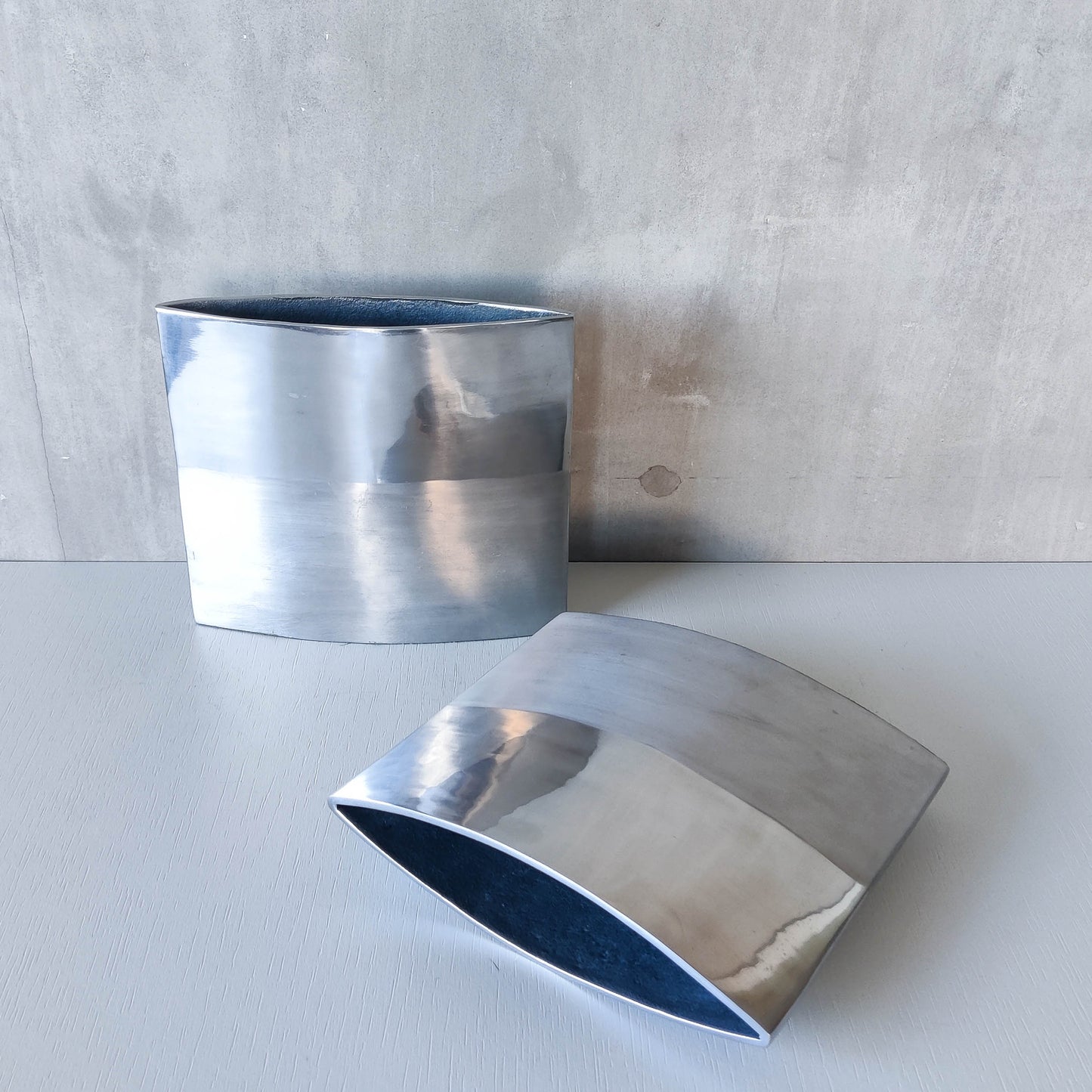 Pair of vintage 00s flat sculptural hand cast aluminium vases