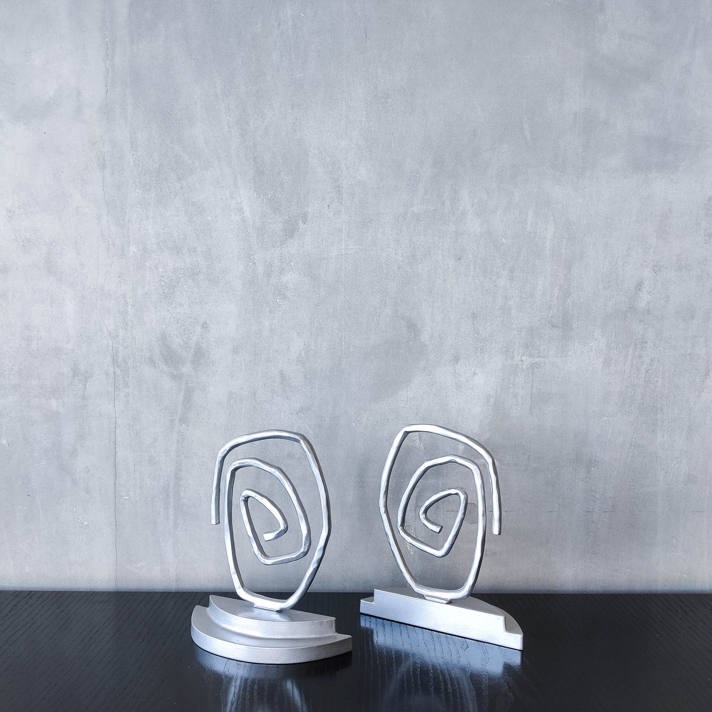 Vintage 1990s post modern style silver metal swirl spiral weighted bookends pair
