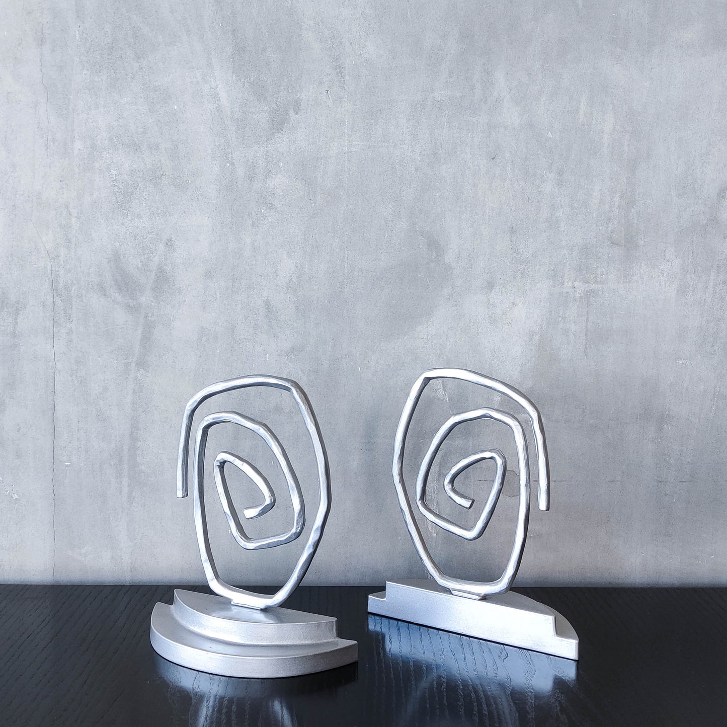 Vintage 1990s post modern style silver metal swirl spiral weighted bookends pair