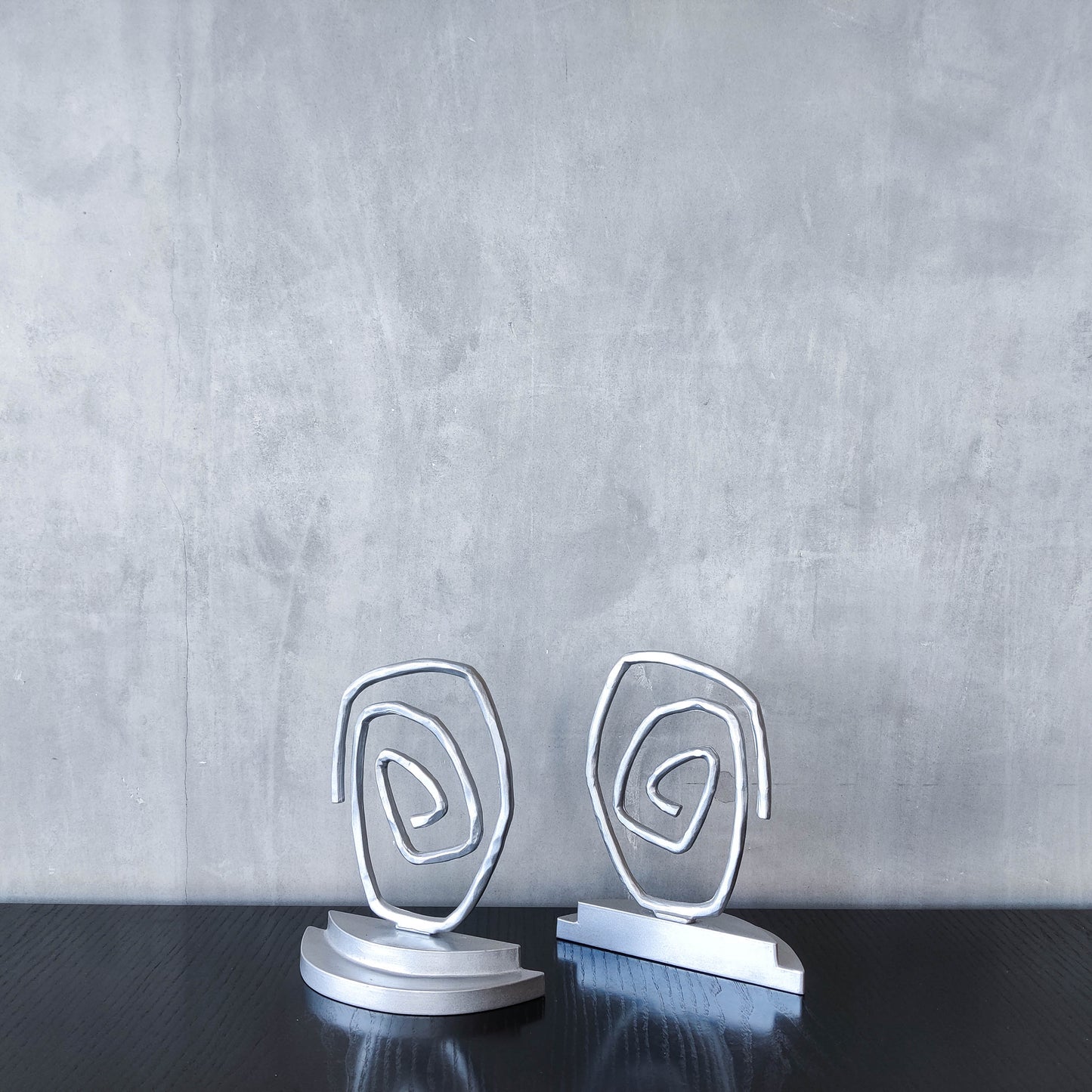 Vintage 1990s post modern style silver metal swirl spiral weighted bookends pair