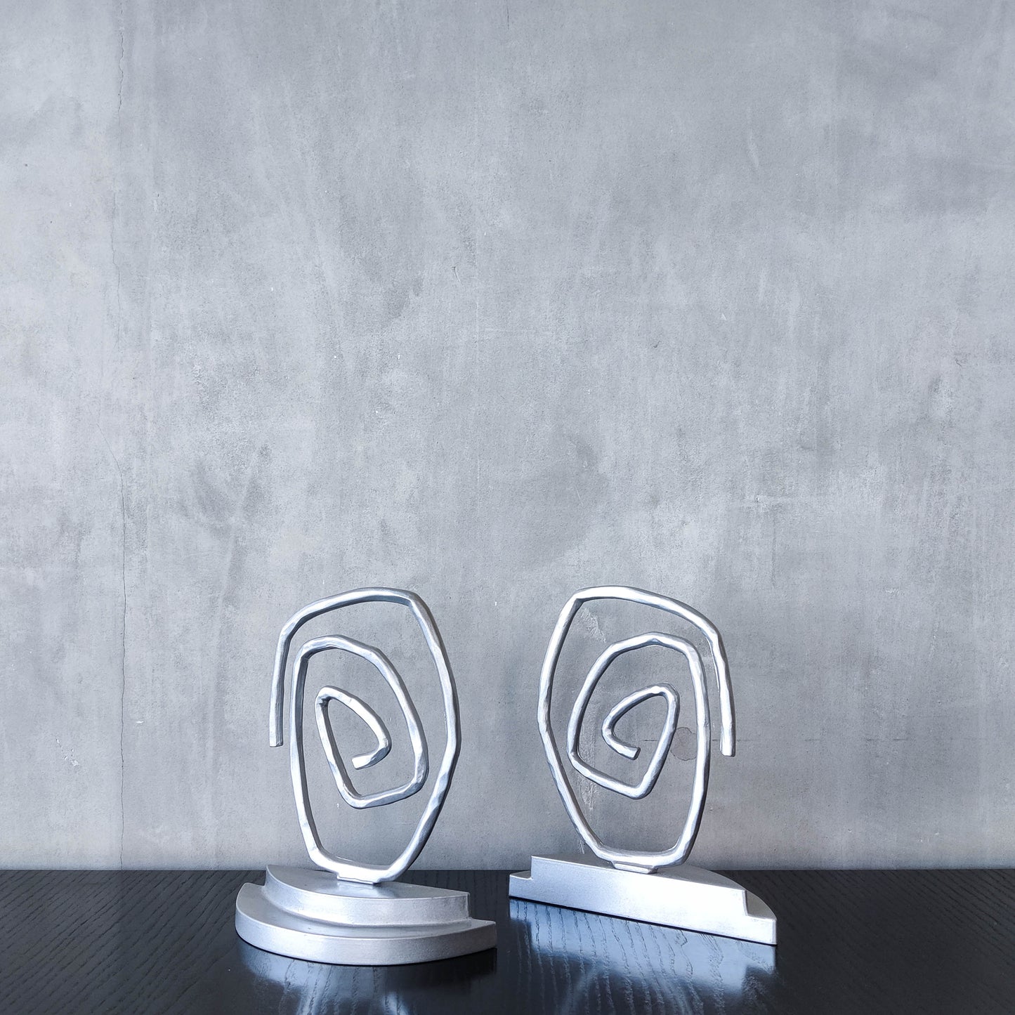 Vintage 1990s post modern style silver metal swirl spiral weighted bookends pair