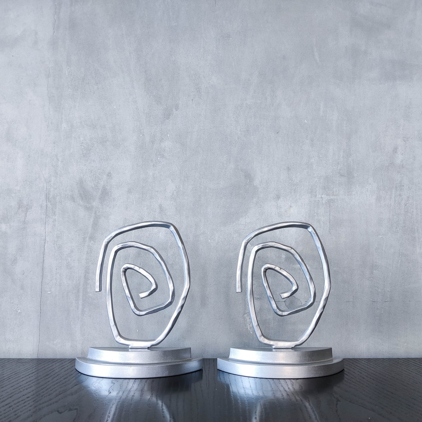 Vintage 1990s post modern style silver metal swirl spiral weighted bookends pair