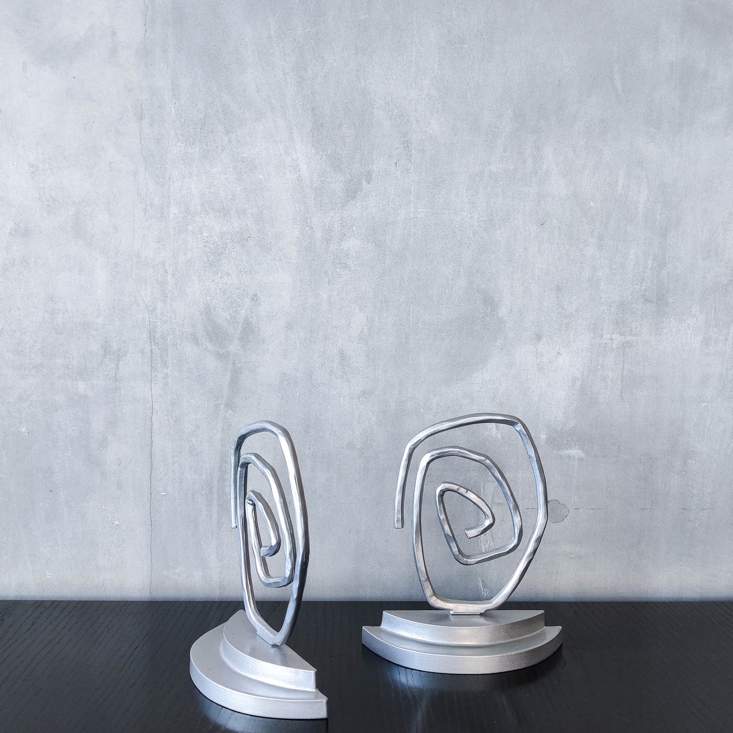 Vintage 1990s post modern style silver metal swirl spiral weighted bookends pair