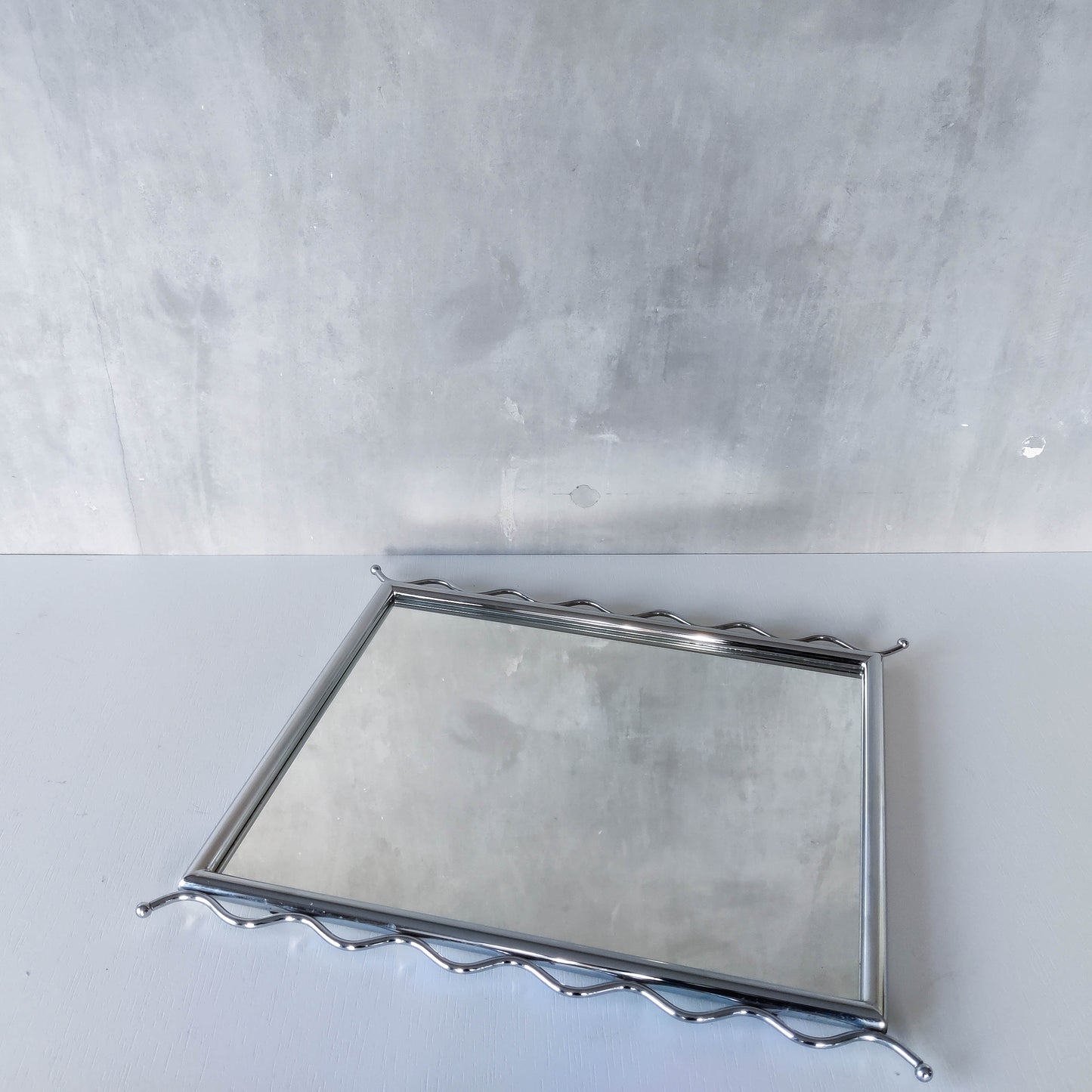 Vintage 1990s postmodern style chrome silver metal mirror with wavy edges