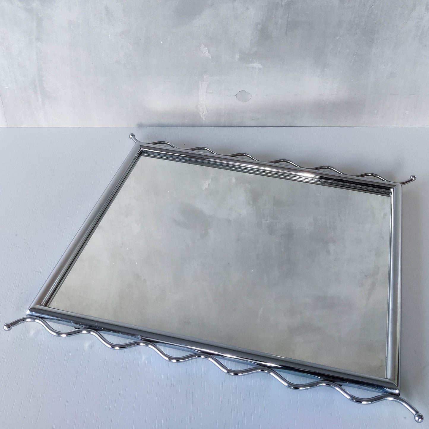 Vintage 1990s postmodern style chrome silver metal mirror with wavy edges