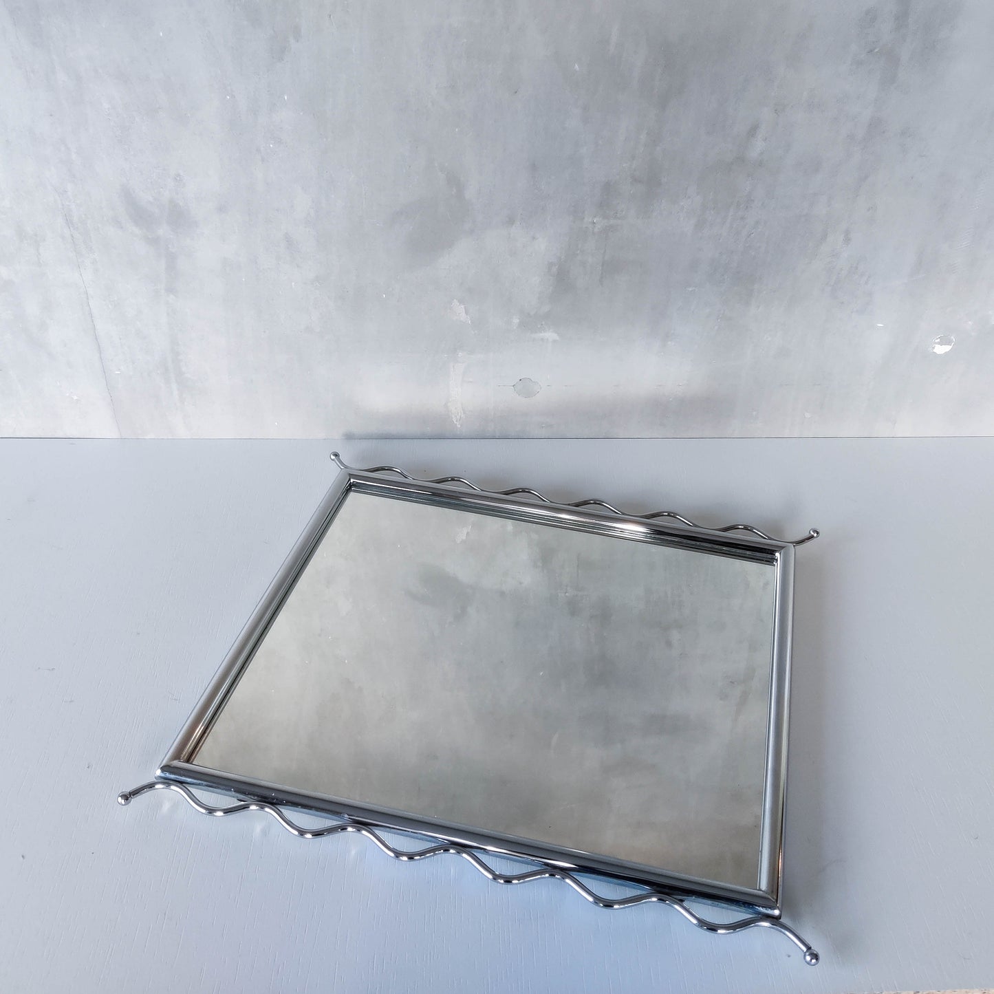 Vintage 1990s postmodern style chrome silver metal mirror with wavy edges