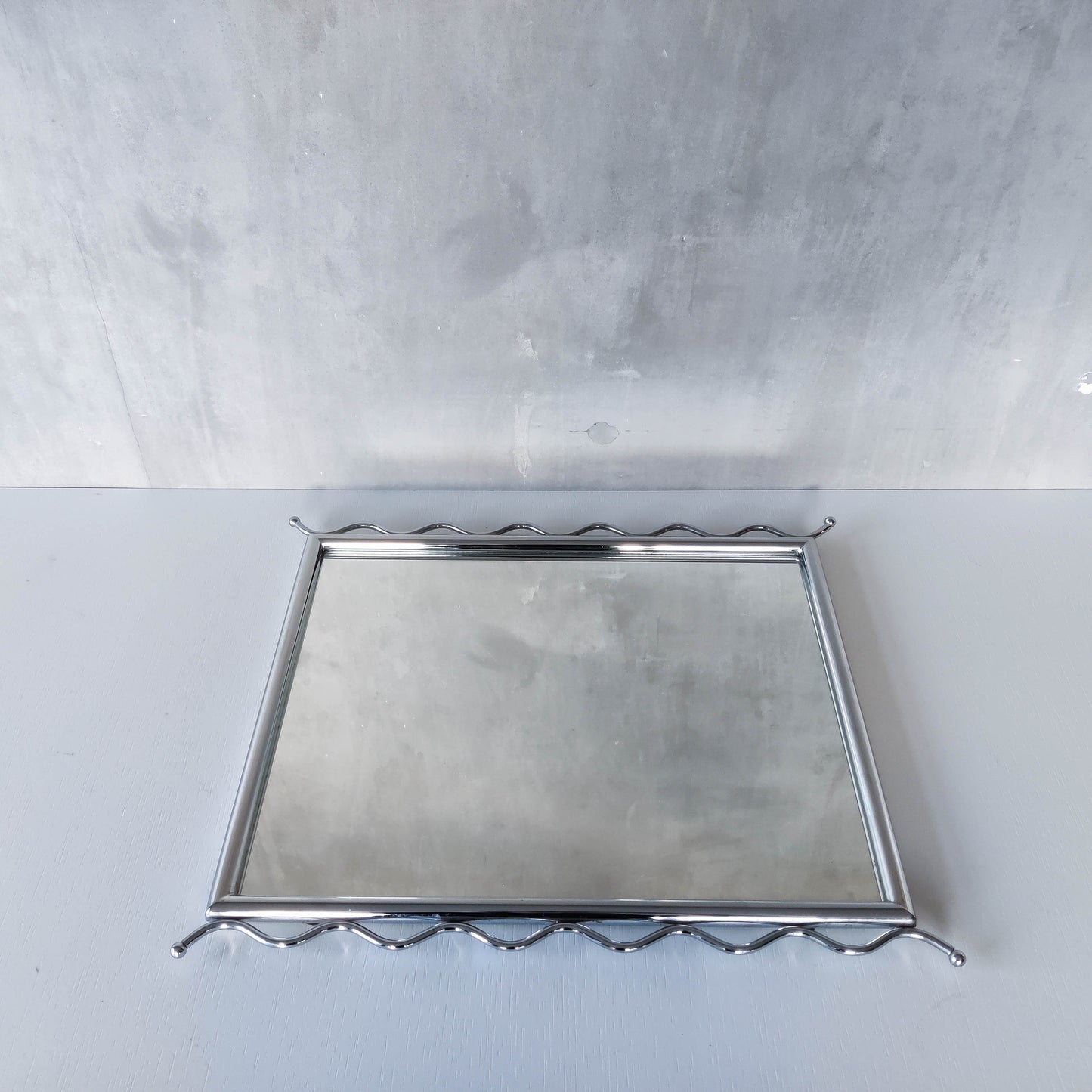 Vintage 1990s postmodern style chrome silver metal mirror with wavy edges