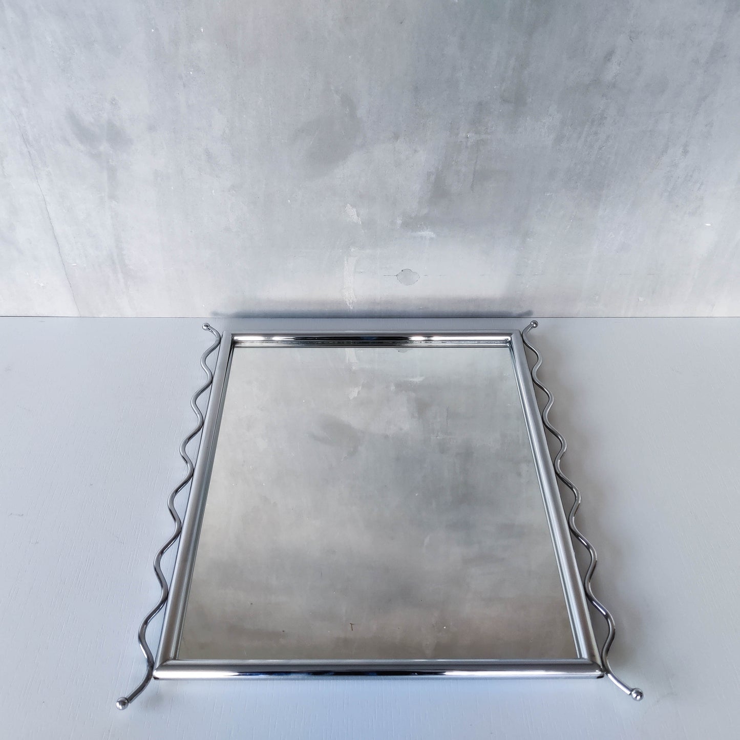 Vintage 1990s postmodern style chrome silver metal mirror with wavy edges