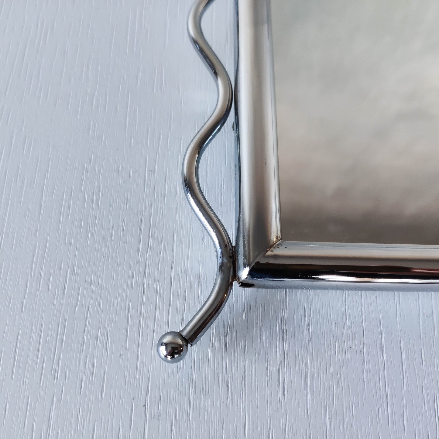 Vintage 1990s postmodern style chrome silver metal mirror with wavy edges