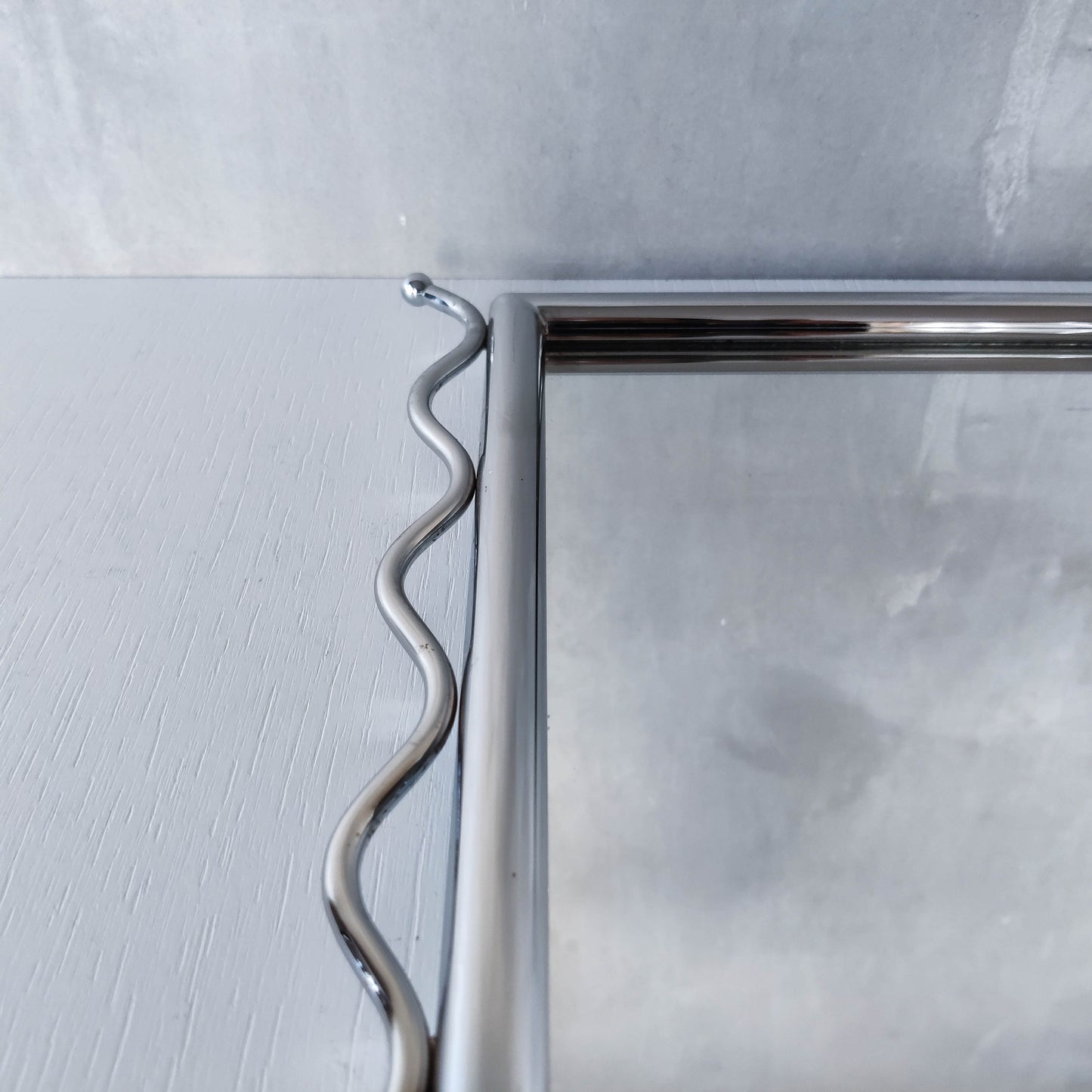 Vintage 1990s postmodern style chrome silver metal mirror with wavy edges