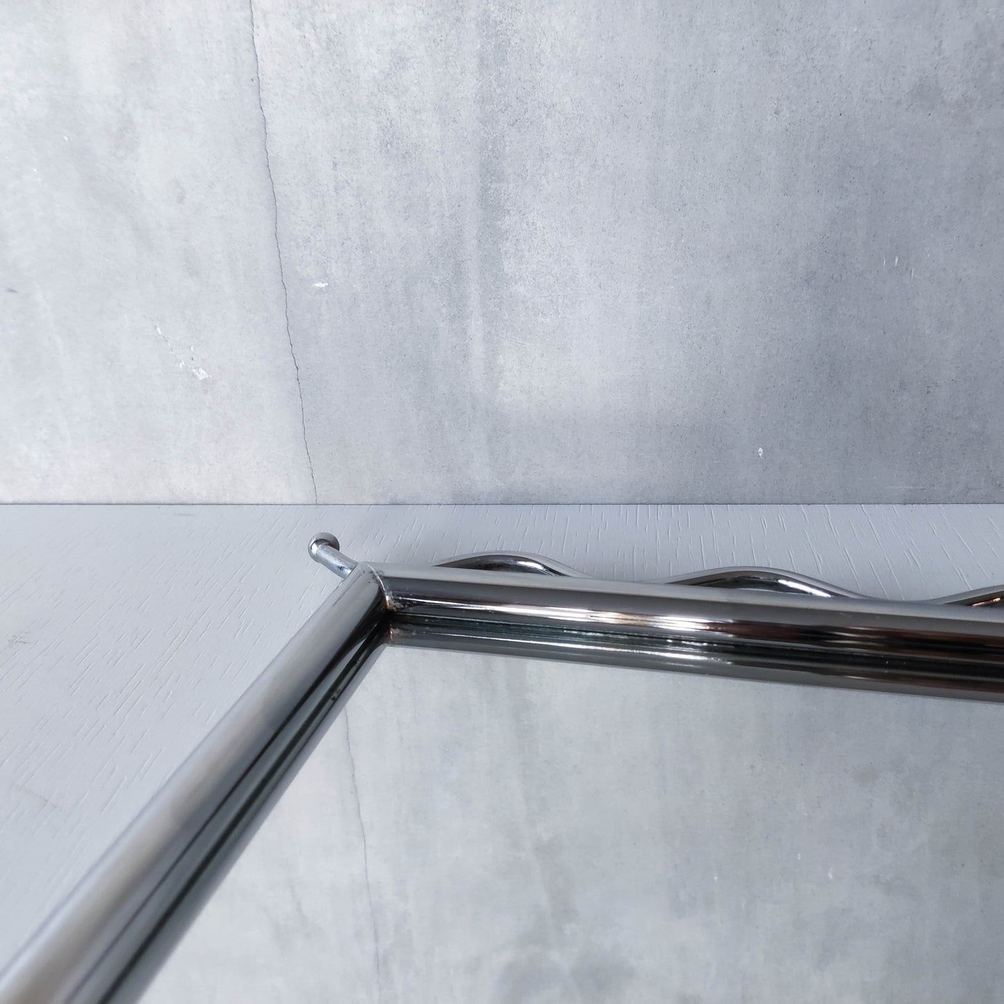 Vintage 1990s postmodern style chrome silver metal mirror with wavy edges