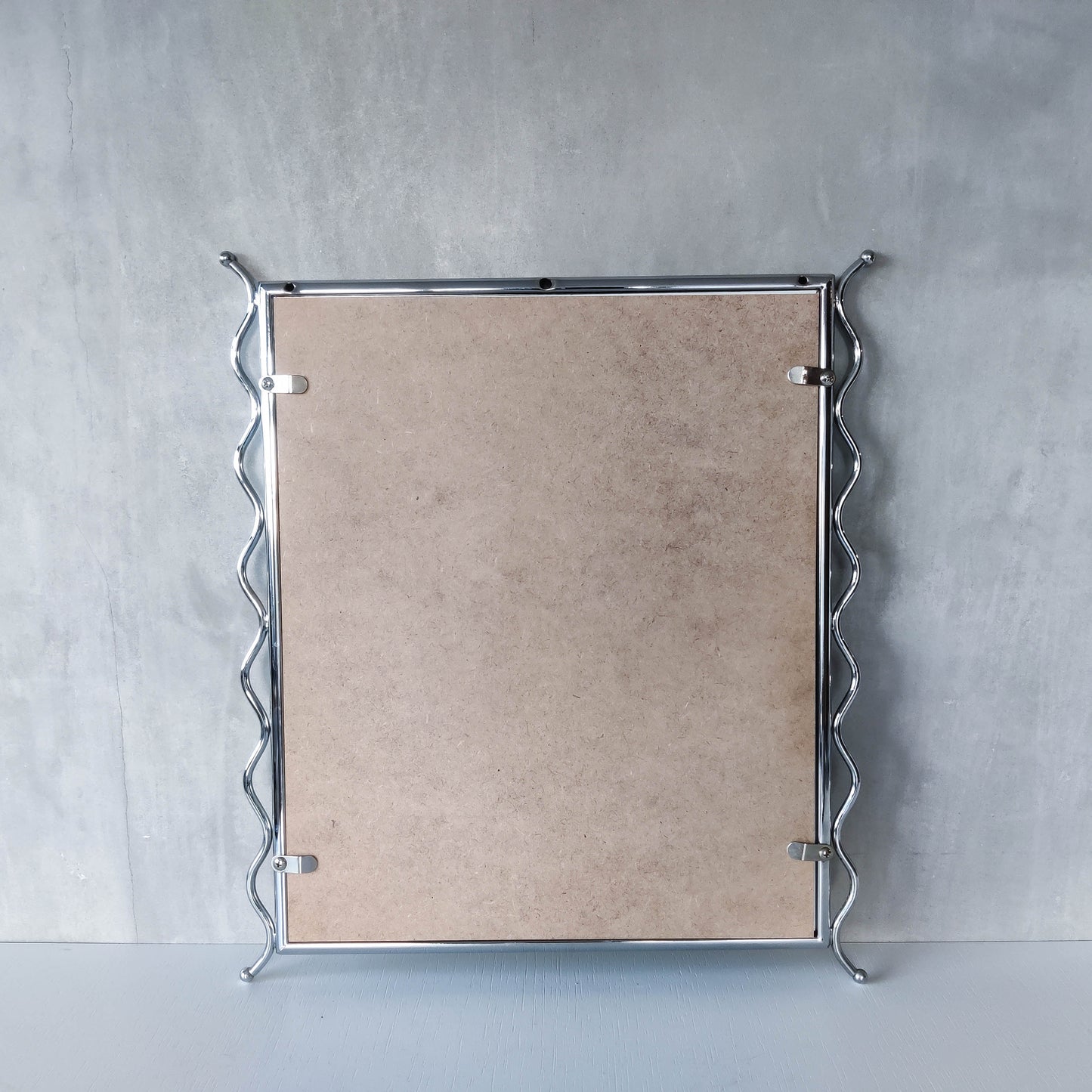 Vintage 1990s postmodern style chrome silver metal mirror with wavy edges