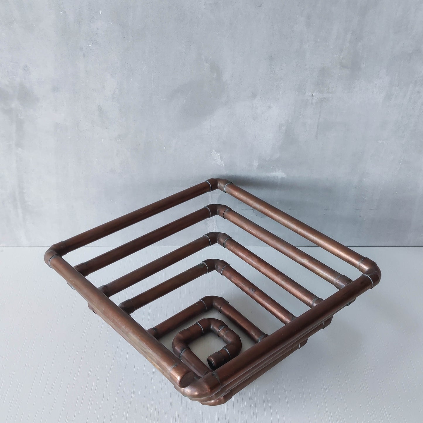 Artisan made sculptural spiral fruit bowl welded patinated copper pipe