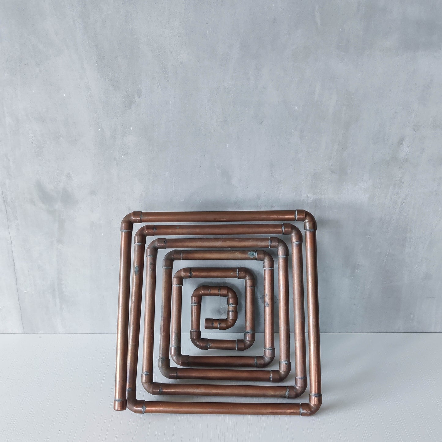 Artisan made sculptural spiral fruit bowl welded patinated copper pipe