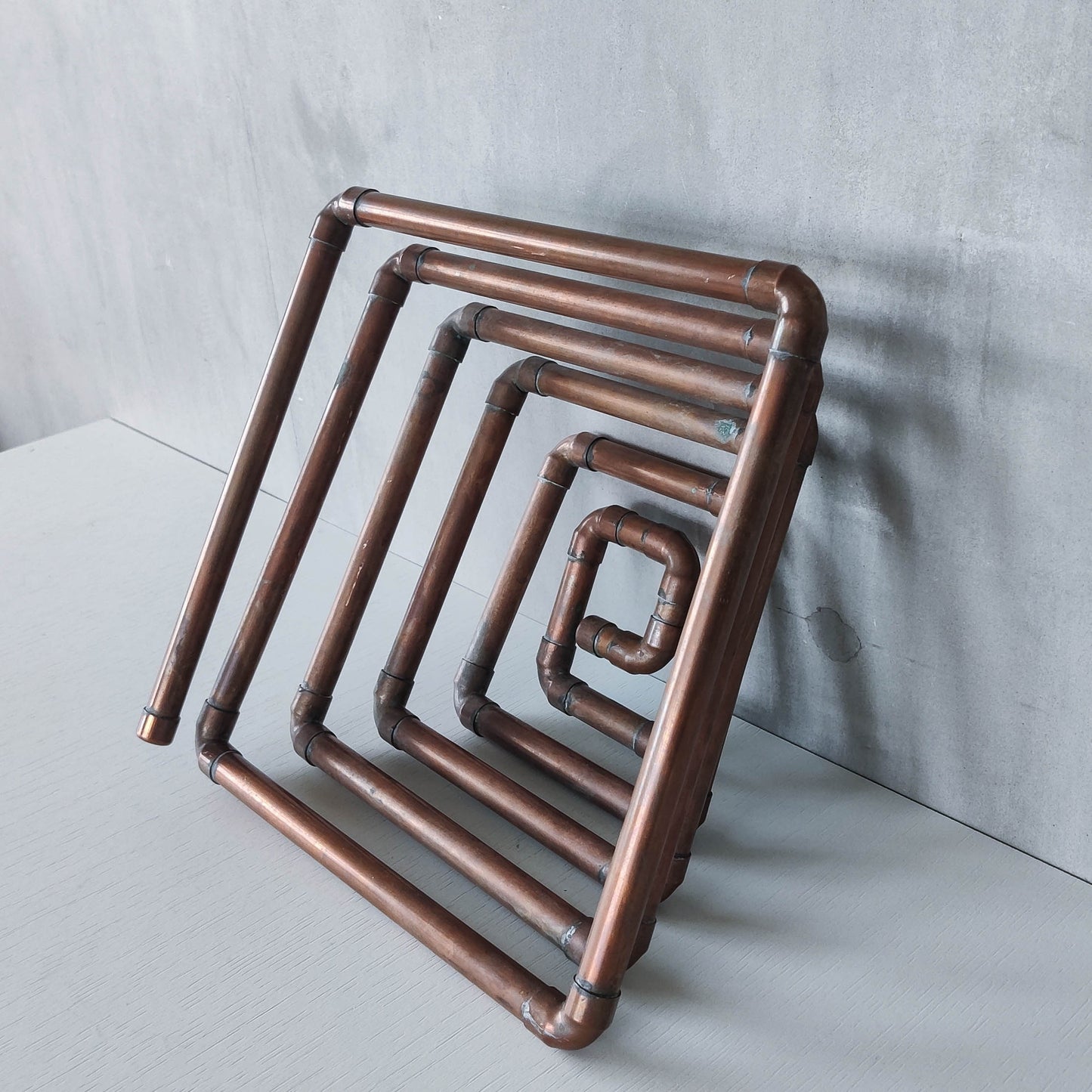 Artisan made sculptural spiral fruit bowl welded patinated copper pipe