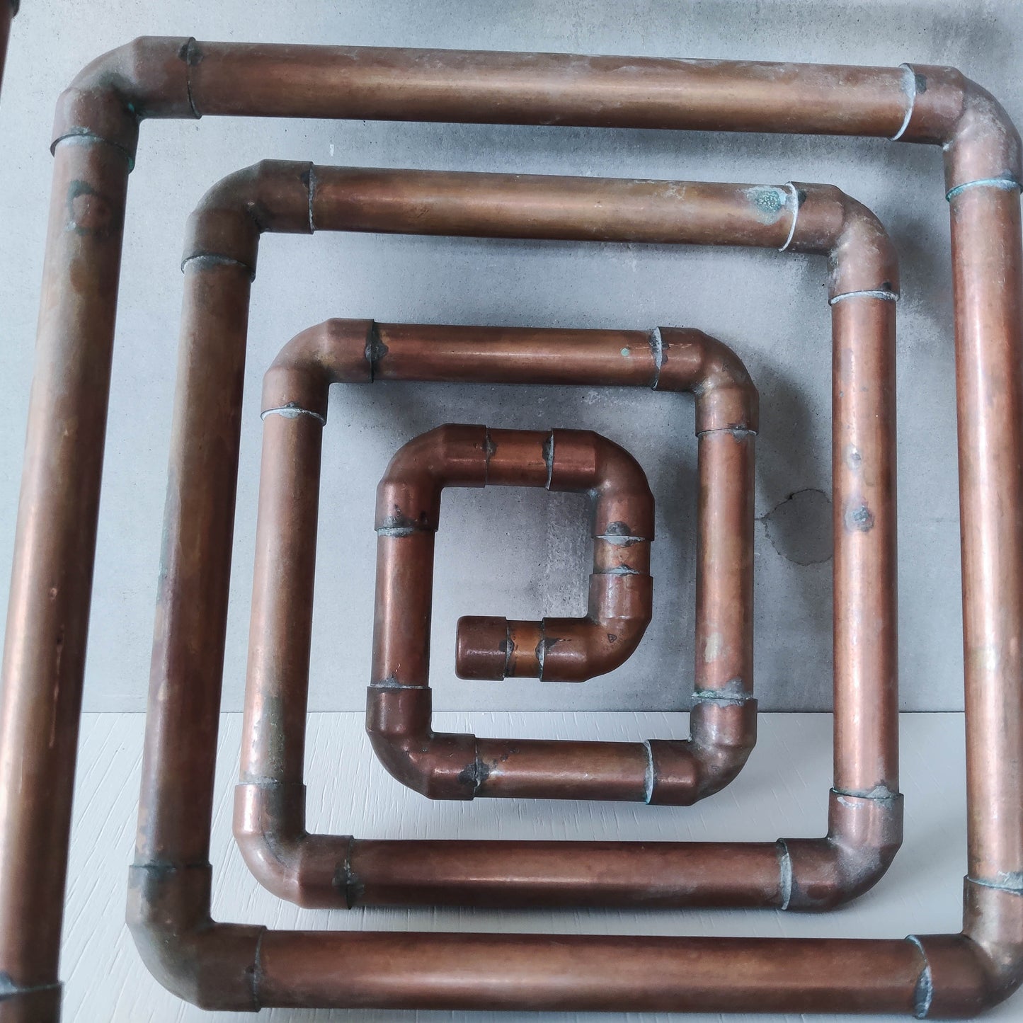 Artisan made sculptural spiral fruit bowl welded patinated copper pipe