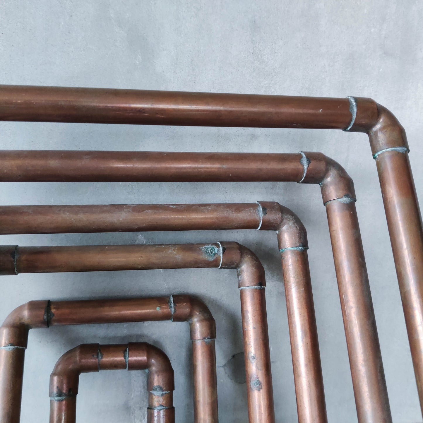 Artisan made sculptural spiral fruit bowl welded patinated copper pipe