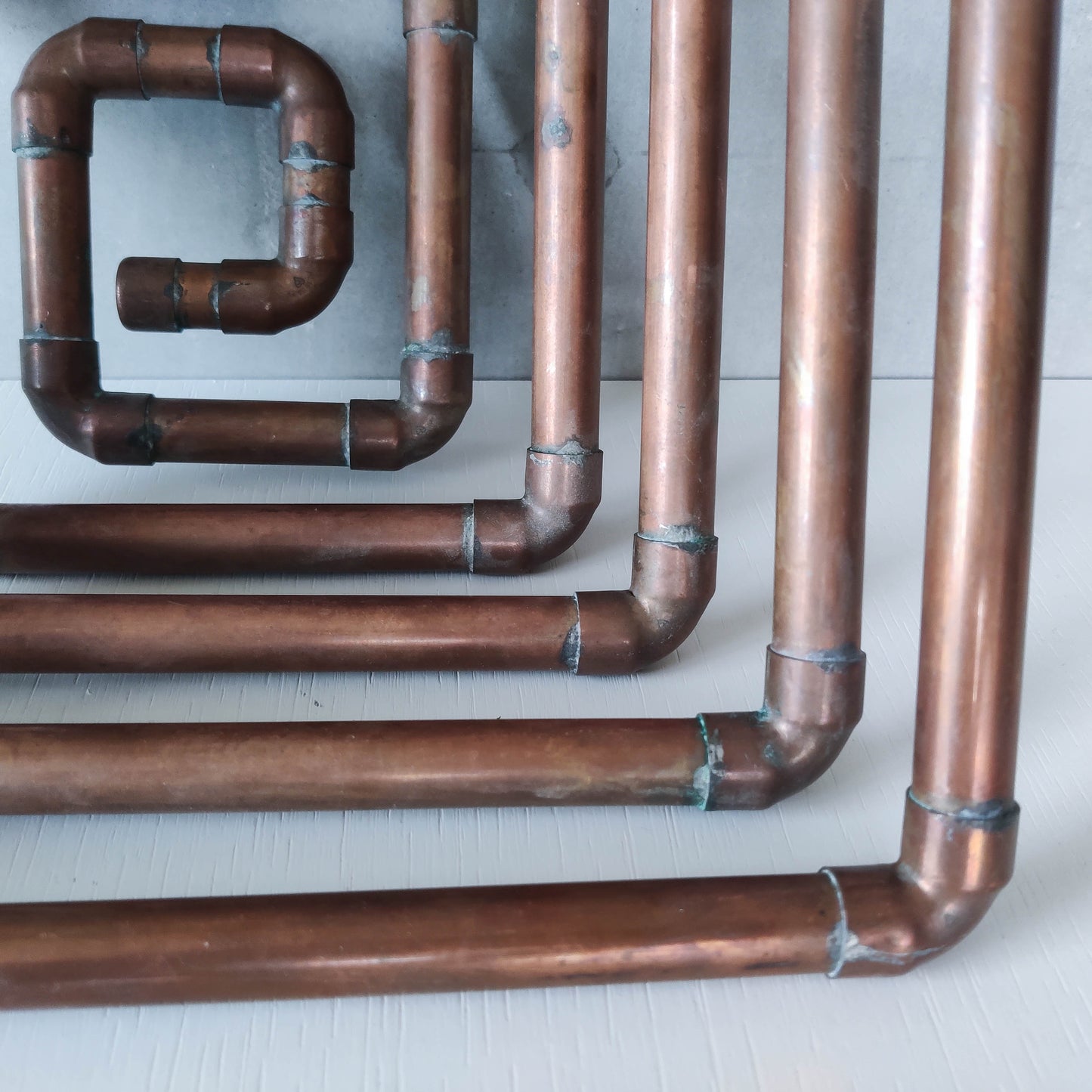 Artisan made sculptural spiral fruit bowl welded patinated copper pipe