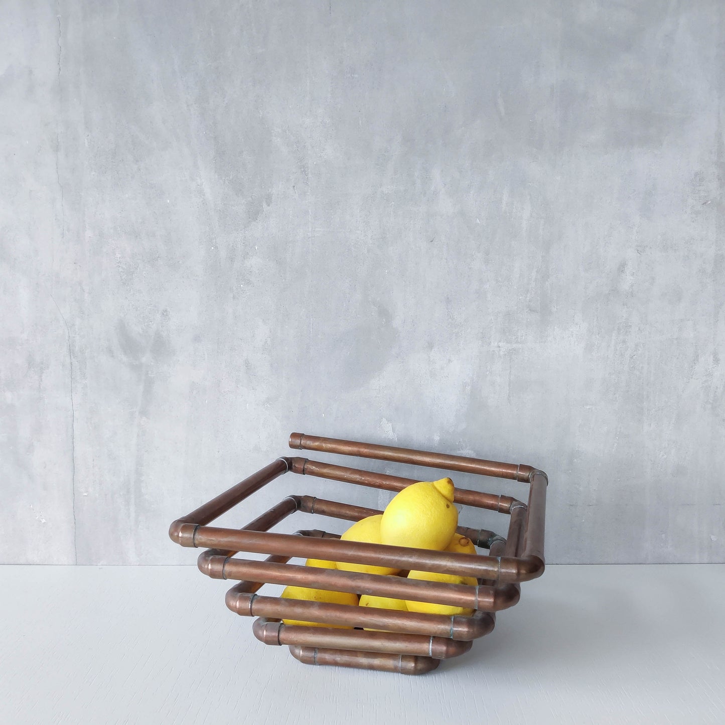 Artisan made sculptural spiral fruit bowl welded patinated copper pipe