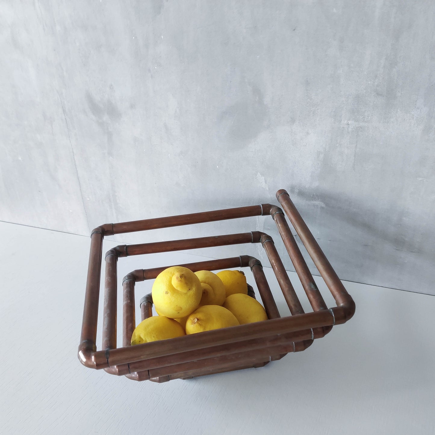 Artisan made sculptural spiral fruit bowl welded patinated copper pipe