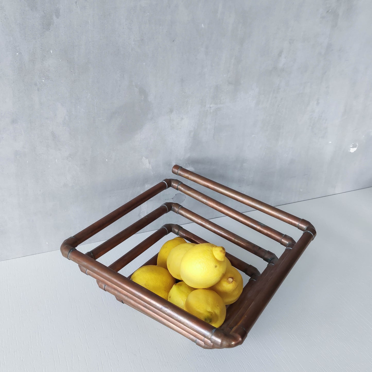 Artisan made sculptural spiral fruit bowl welded patinated copper pipe