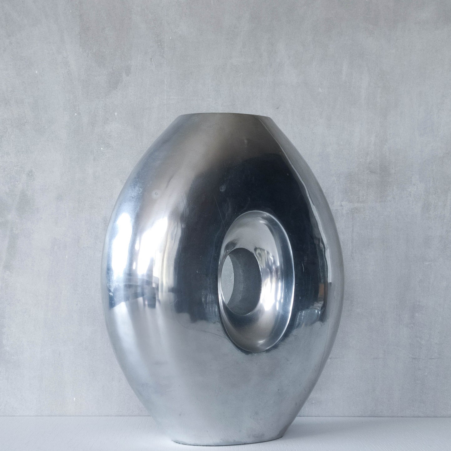 Vintage large sculptural modernist hand cast aluminium oval donut vase